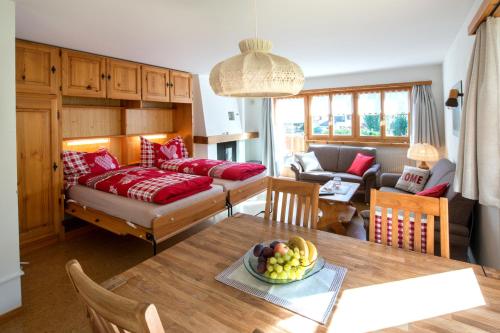 ein Wohnzimmer mit einem Tisch und einem Sofa in der Unterkunft Ferienwohnungen Muntschi in Andeer