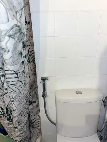 une salle de bain avec toilettes et rideau de douche dans l'établissement Studio en résidence avec parking, au Cap d'Agde
