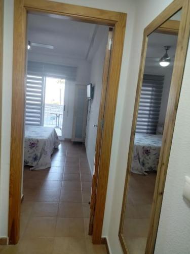 a hallway with two beds in a room with a mirror at Apartment Cala Dor in El Campello