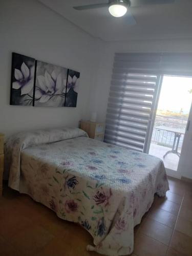 a bedroom with a bed in a room with a window at Apartment Cala Dor in El Campello