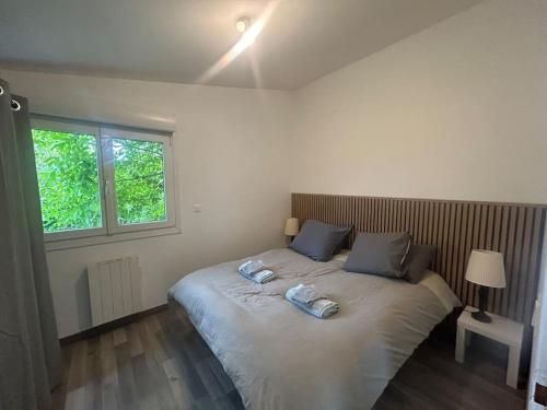 a bedroom with a bed with two phones on it at maison proche du Groupama Stadium in Décines-Charpieu