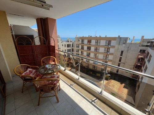 a balcony with chairs and a view of a building at Julia Vigo Panorama apartments in Nesebar