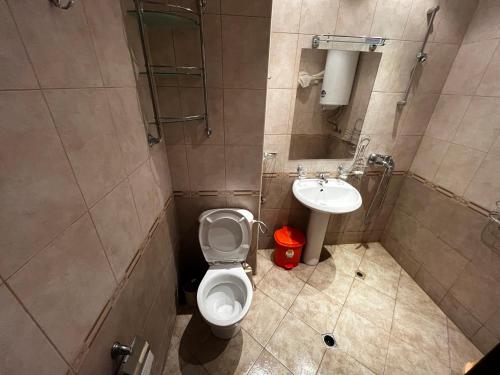 a bathroom with a toilet and a sink at Julia Vigo Panorama apartments in Nesebar