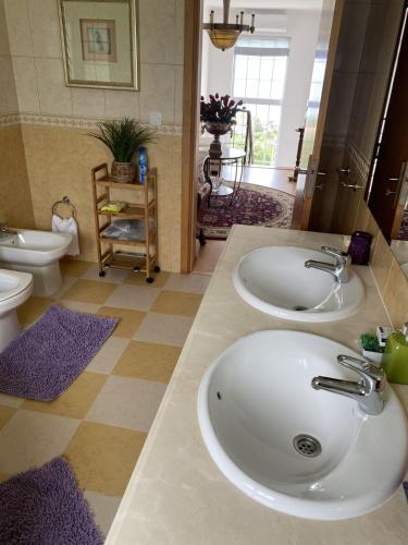 a bathroom with two sinks and a toilet at Vista do Topo in Povoação
