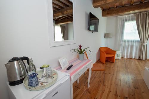a kitchen with a white counter top and a table at Il Casale-toscoemiliano in Camugnano