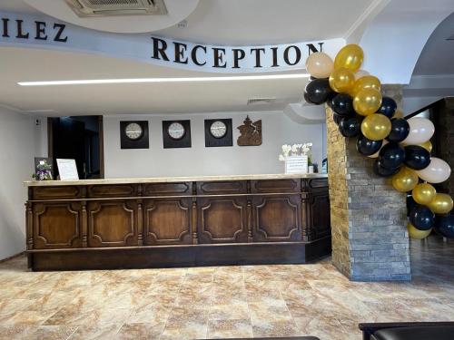 a reception area with balloons and a reception counter at Хотел Хилез Hotel Hilez in Tryavna