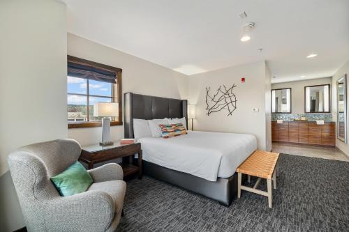 a bedroom with a bed and a chair and a bed and a couch at Oxford Hotel Bend in Bend