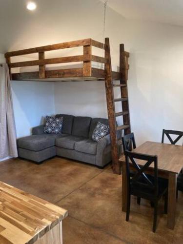 a living room with a couch and a bunk bed at Gold Valley Camp Cabin 2 in Custer