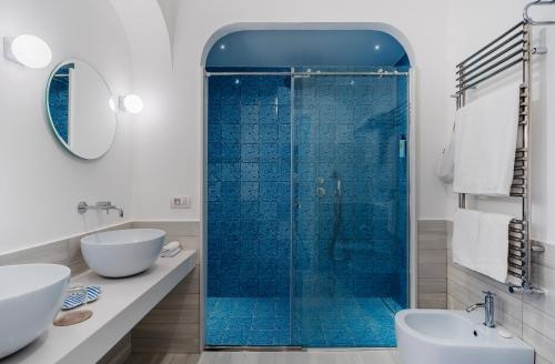 a bathroom with a glass shower and a sink at Boutique Hotel Casa Mariantonia in Anacapri