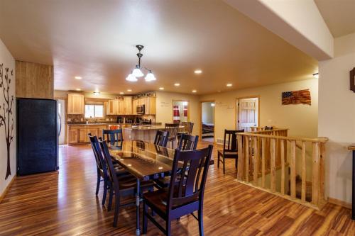 a dining room and kitchen with a table and chairs at Custer Connection in Nihart
