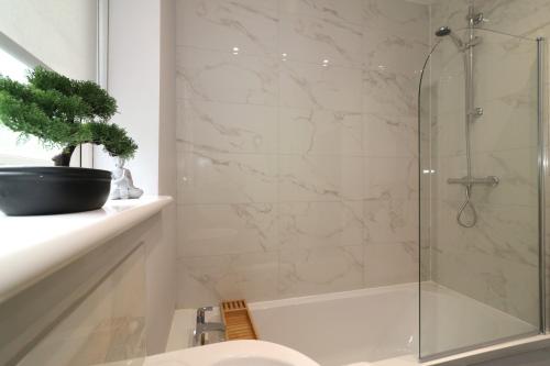 a bathroom with a shower and a toilet and a sink at Signature - Huntley House in Glasgow