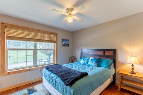 a bedroom with a bed and a ceiling fan at Park Creek Place in Hill City
