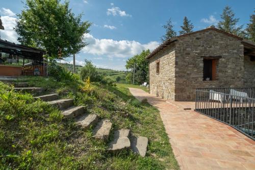 a stone building with stairs next to a building at Il Casale-toscoemiliano in Camugnano