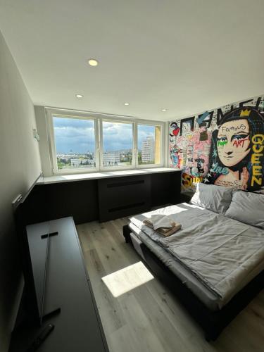 a bedroom with a bed with a mural on the wall at IOS ArtPrg in Prague