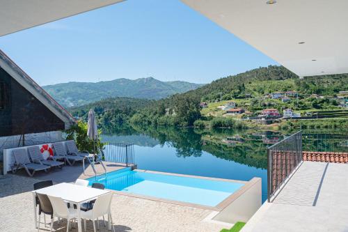a house with a view of a lake at Lajinha do Ave in Azevedos