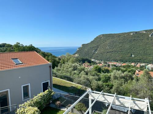 a view from the balcony of a house with mountains in the background at Villino con terrazzo panoramico in Finale Ligure