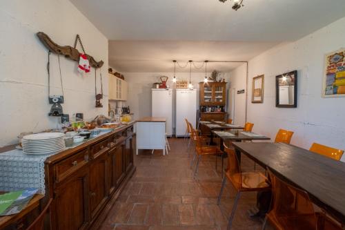 a kitchen with wooden cabinets and tables and a refrigerator at Il Casale-toscoemiliano in Camugnano