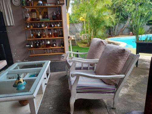 two chairs sitting next to a table and a pool at KazTiFahamAimée in Saint-Louis