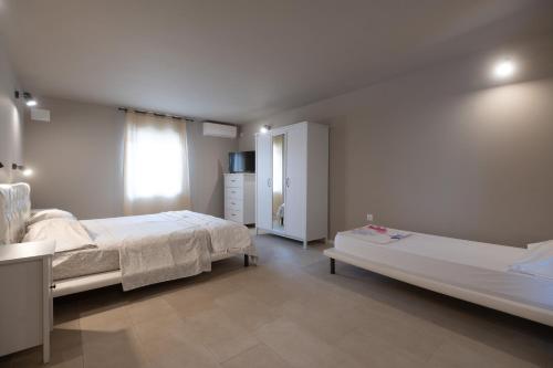 a bedroom with two beds and a dresser in it at Holiday Home LI-ZA in Privlaka