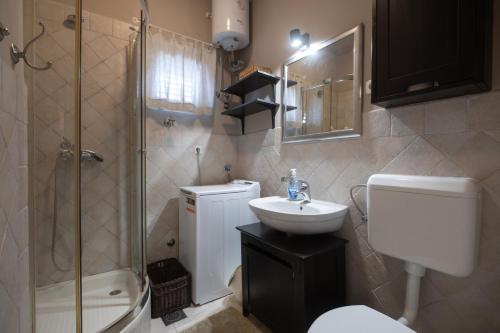 a bathroom with a toilet sink and a shower at Holiday Home LI-ZA in Privlaka