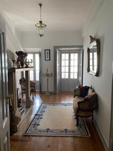 a living room with a couch and a rug at Pátio da Villa - Coruche Boutique Guest House in Coruche