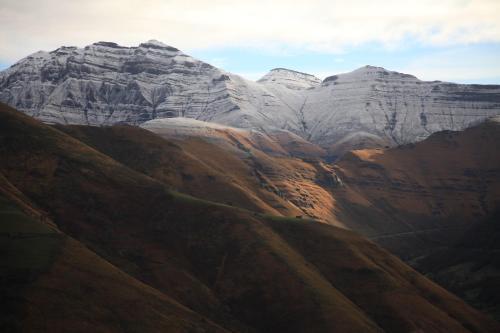 a group of mountains with the sun shining on them at La cabaña mirador de los Valles Pasiegos in Vega de Pas