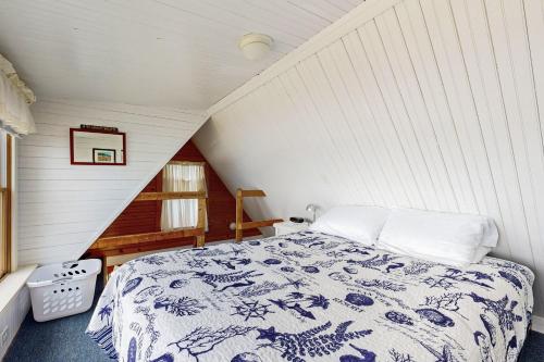 a bedroom with a bed in a attic at Dream Harbor Cottage in Surry