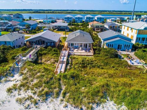an aerial view of a beach with houses and the ocean at A Charm of Finches in Surf City