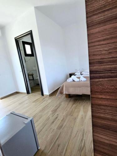 a bedroom with a bed and a large mirror at Ambelas Getaways in Himare