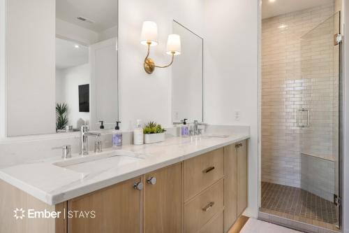 a bathroom with a double sink and a shower at Laguna Matata at Desert Color (by Ember Stays) in St. George