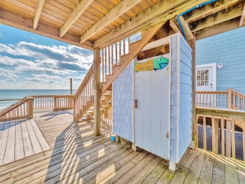a house with a deck with the ocean in the background at A Grande Green in Surf City