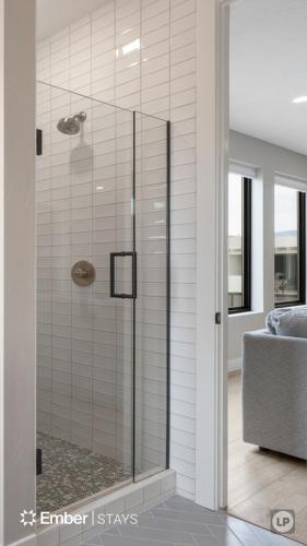 a shower with a glass door in a bathroom at The Solace at Desert Color by Ember Stays in St. George
