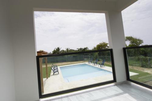 a room with a large window and a swimming pool at Isabela on the Cliff in Isabela
