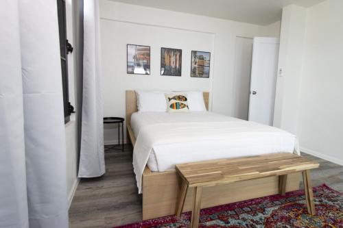 a bedroom with a white bed and a wooden table at Isabela on the Cliff in Isabela