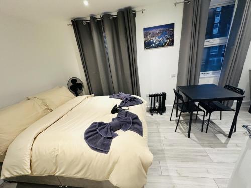 a bedroom with a bed and a table and a table at Studio in Oval London in Bellaghy