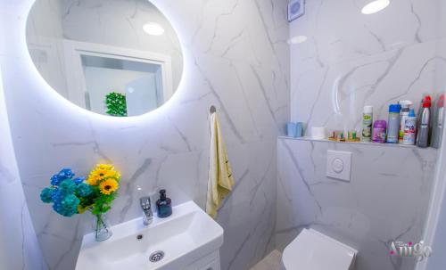 a white bathroom with a sink and a mirror at Villa Elysian Blagaj in Blagaj