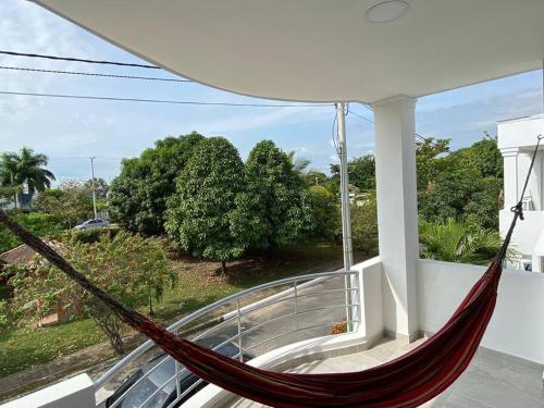 a hammock on the balcony of a house at Vacation home in Flandes in Flandes