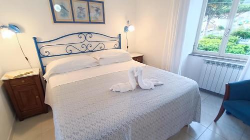 a bedroom with a bed with a stuffed animal on it at Hotel Casa Nicola in Ischia