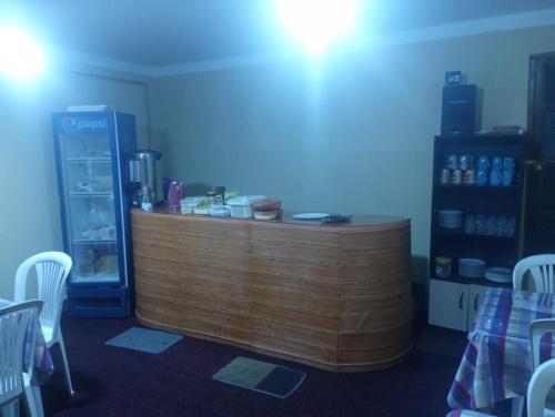 a wooden counter in a room with a refrigerator at Hostal La Realeza in Potosí