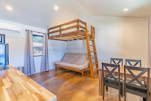 a dining room with a bunk bed and a table at Gold Valley Camp Cabin 1 in Custer