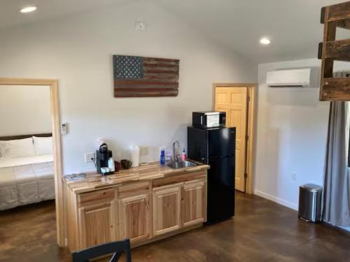 a kitchen with a sink and a refrigerator in a room at Gold Valley Camp Cabin 1 in Custer
