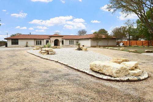 a house with a lot of rocks in the driveway at Guadalupe Bluff Mediterranean in Kerrville