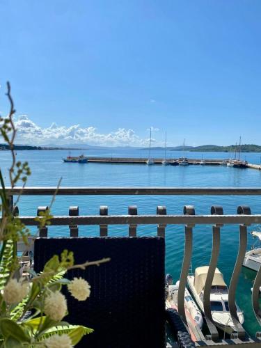 a bench sitting in front of a body of water at Villa Adria in Vodice
