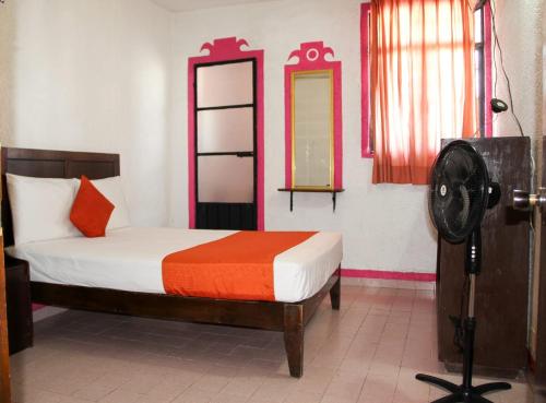 a bedroom with a bed and a mirror and a camera at Hotel Huautla de Oaxaca in Oaxaca City