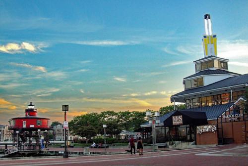 a building with a lighthouse and a building with a tower at Pier 5 Hotel Baltimore in Baltimore