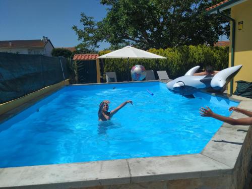a group of people playing in a swimming pool at Casa da Ereira in Montemor-o-Velho