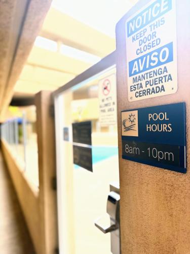 a sign is posted on a door in a store at The Pacific Inn in Seal Beach