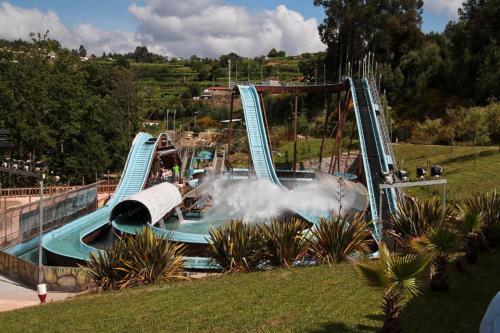 a water slide in a park with people on it at Vila Teixeira in Amarante