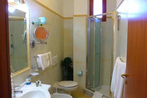 a bathroom with a shower and a toilet and a sink at Hotel Residence Piccolo in Parghelia