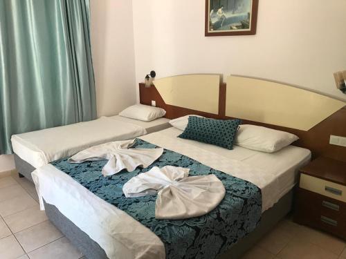 Postel nebo postele na pokoji v ubytování Best Hotel